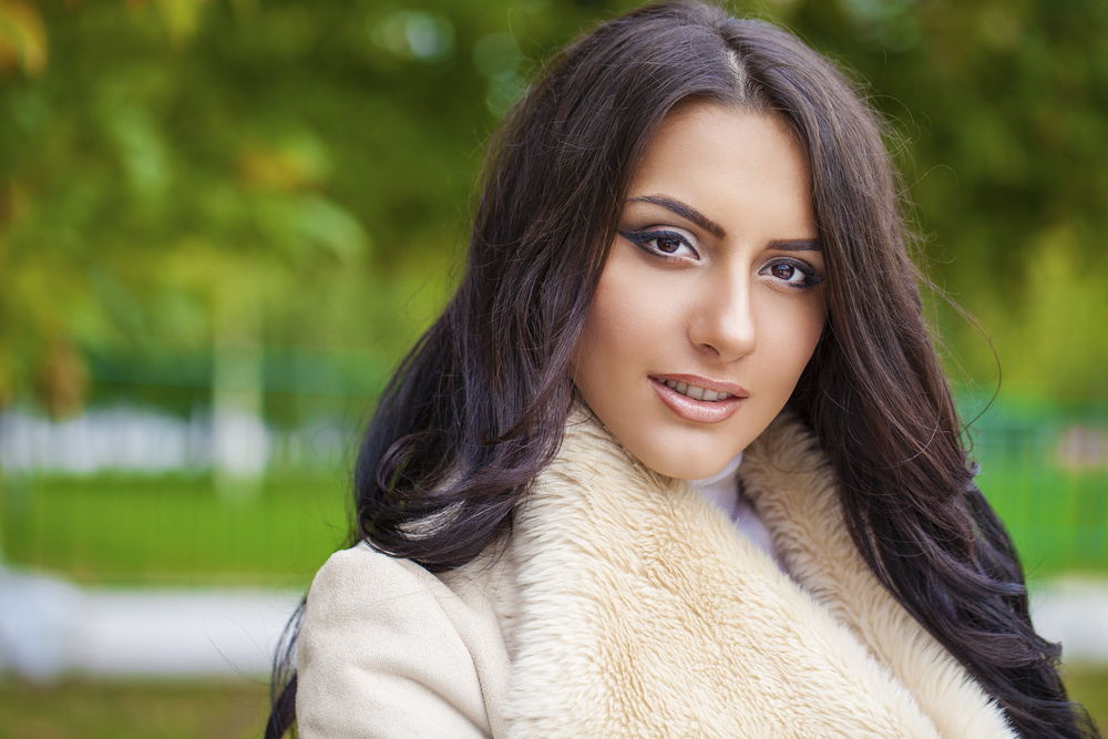 Facial portrait of a beautiful arab woman warmly clothed outdoor