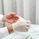 Doctor taking off the gloves
