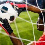 brazilian man goalkeeper catches the ball in the stadium during a football training