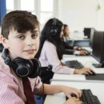 Students using computer in classroom