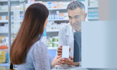 Female client standing near the pharmacy counter