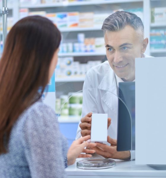 Female client standing near the pharmacy counter