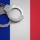 France flag and police handcuffs. The concept of crime and offenses in the country.