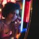 USA, Nevada, Las Vegas, portrait of young woman at slot machine in a casino